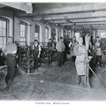 Seven men working in the Pittsfield Broom Making workshop.