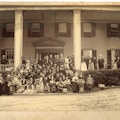 Group photograph of the first summer American Association To Promote Teaching Speech To The Deaf meeting taken on a Lake George porch with Alexander G. Bell positioned center with beard.