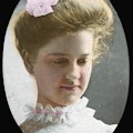 Mildred Keller with ruffled collar, looking down and to right, colored.