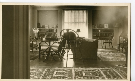 Empty parlor at the Wright Oral School with two couches in the center of the room and a window in the right background.
