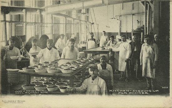 Seventeen men in an insitutional kitchen.