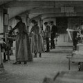 Young men and women in woodworking shop.