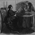 Woman sitting in chair at table reading book to three girls