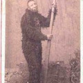 An African-American man in a fur suit holds an oar.