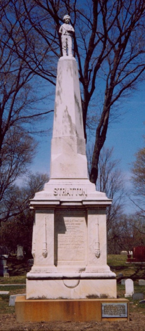 A very monument with a life-size statute of Tom Thumb on top.