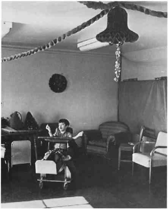 A boy in a room with Christmas decorations.