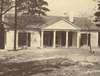 A small single-storied house with pillars in front.