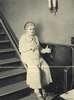 An elderly woman using an incline stair elevator.