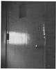 Light shining on a metal door.
