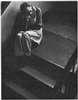 A man sitting on stairs.