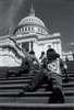Two young people crawl up the steps of the Capitol Building.