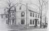 Photograph of the Cogswell House, a large townhouse, with a horse drawn carriage on the street in front.