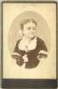 Bust view, oval format, of Lavinia Warren in dark velvet dress with jewelry.
