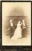 Two small-statured men with Minnie Warren between them.