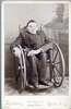 A young man in a wheelchair in a Victorian home.