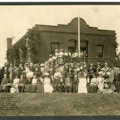 Group photograph in front of brick building.