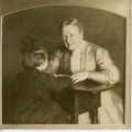 Sarah Fuller sits facing child.