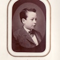 Portrait of Arthur C. Andrew, as a boy in three-quarter profile wearing a wool coat and plaid cravat.