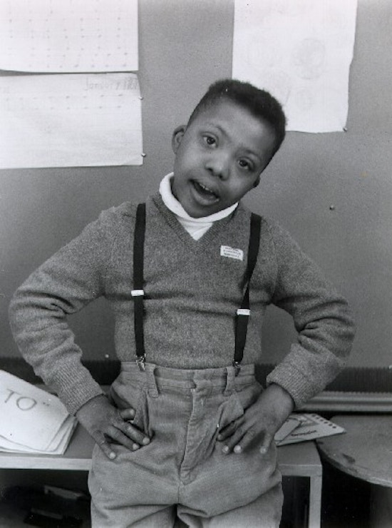 Photograph of a young African-American boy in a sweater and suspenders.