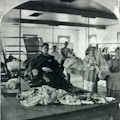 Stereo card of men and women at work in the laundry at Willard Asylym.