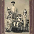 Portrait of mother, father, and two children, one in a wheelchair.