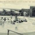 Postcard photograph of children playing in a pool.