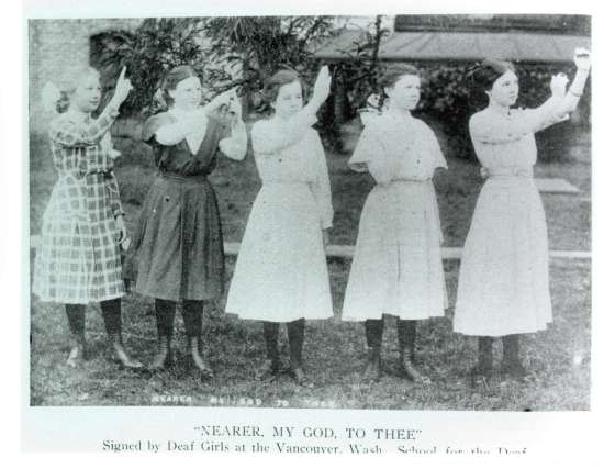 Five young women standing on the grounds of Vancouver, Washington School for the Deaf sign the hymn "Nearer My God, To Thee".