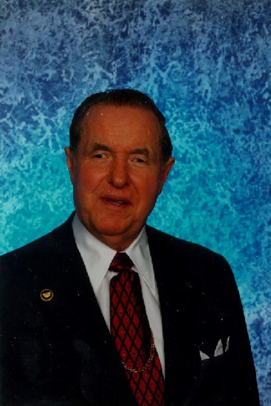 Formal portrait of Jernigan with a blue backdrop.