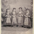 Four small-statured women standing.