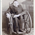 A young man in a wheelchair in a Victorian home.