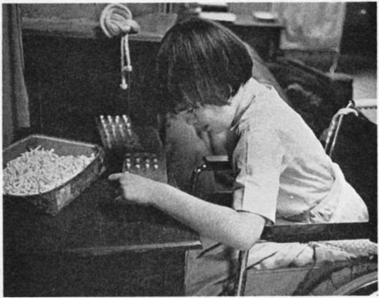 A child works with a peg board.