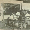 A man at a blackboard illustrates the way Goddwill works.